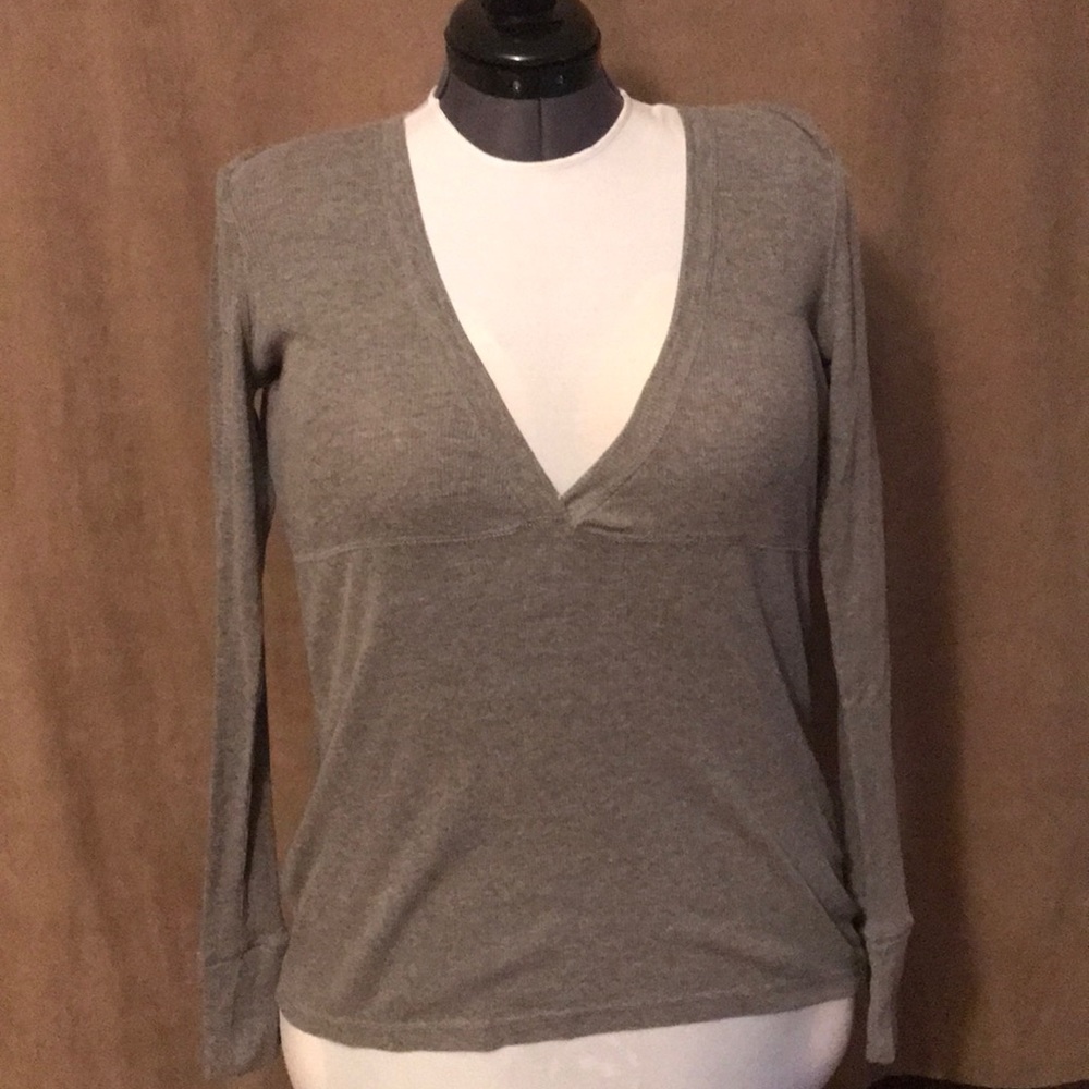 Grey, long sleeve v-neck shirt.